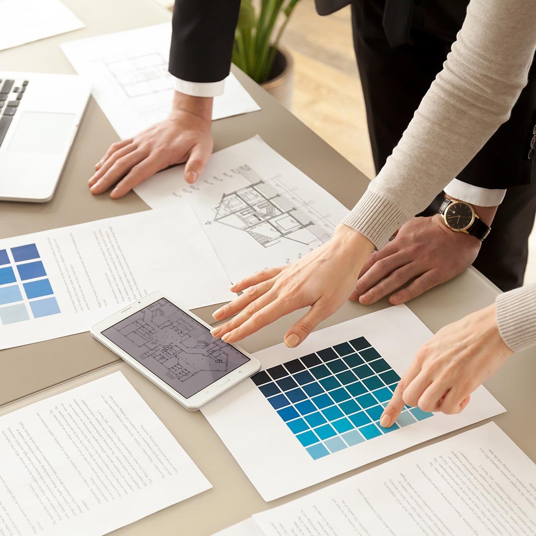 Designers using a tablet and looking at color schemes