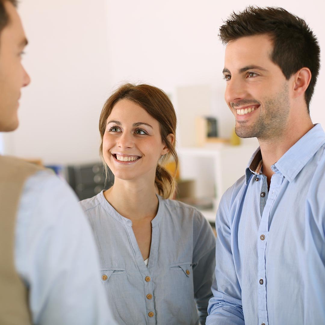 Happy couple meeting with a man