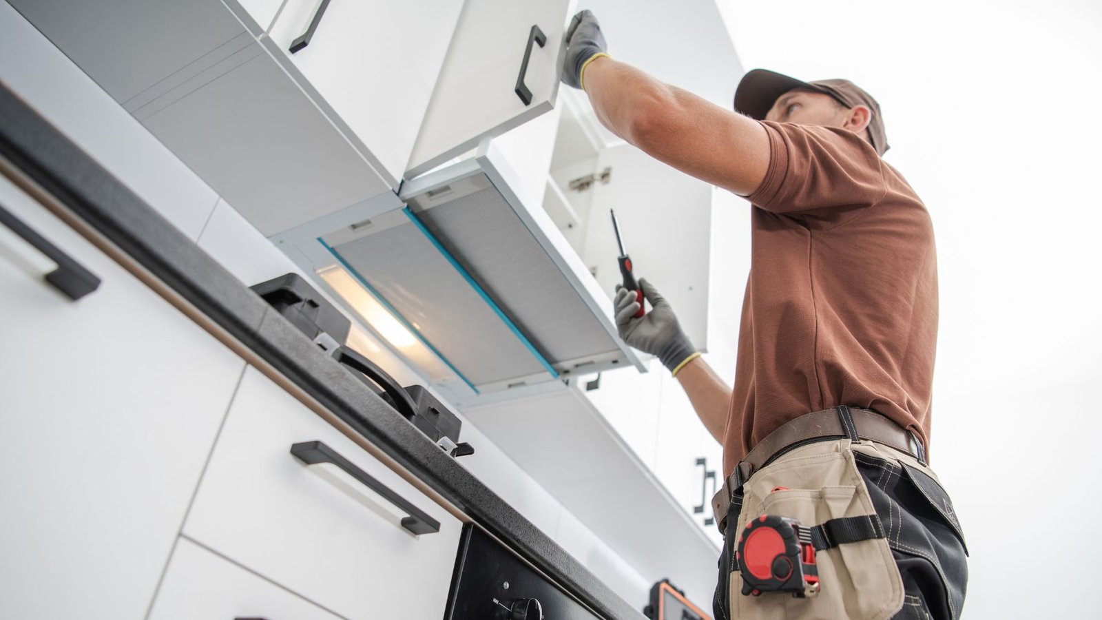 contractor installing new kitchen cabinets
