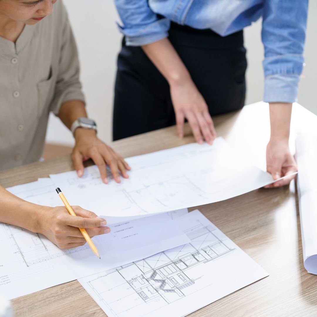 people reviewing architectural drawings
