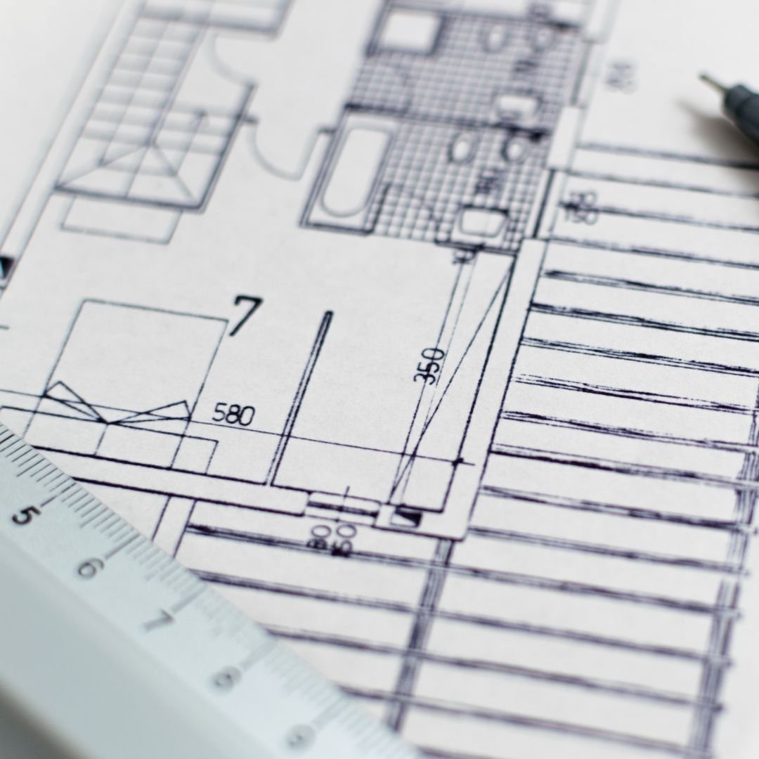 close up of architectural drawings with ruler and pencil