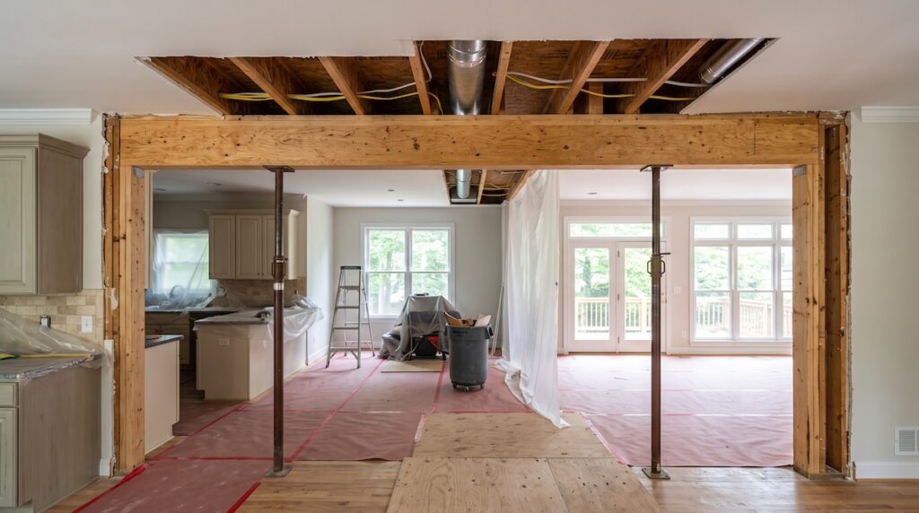 a home renovation where an interior wall between a kitchen and living room has been removed